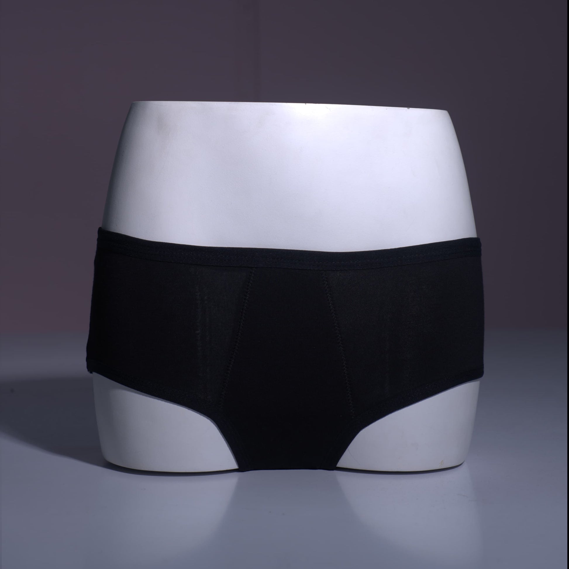 Healthfab GoPadFree Black color Period underwear Hipster Mid rise on a reflective surface with a dark background
