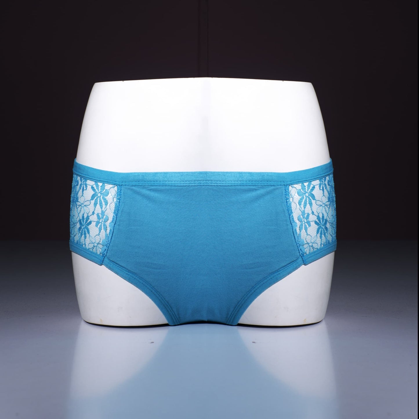 Blue underwear with lace details on a mannequin against a dark background