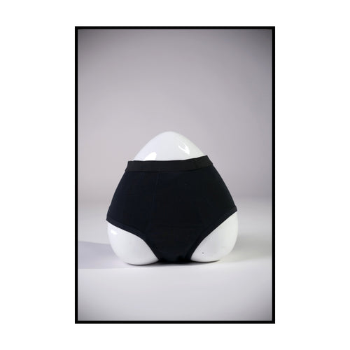 Black underwear on a white mannequin against a gray background