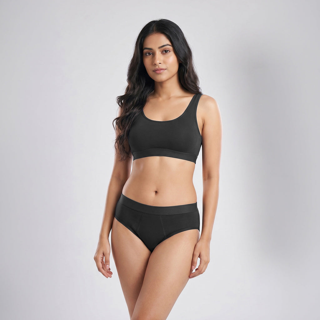 Woman wearing a black bikini set on a gray background