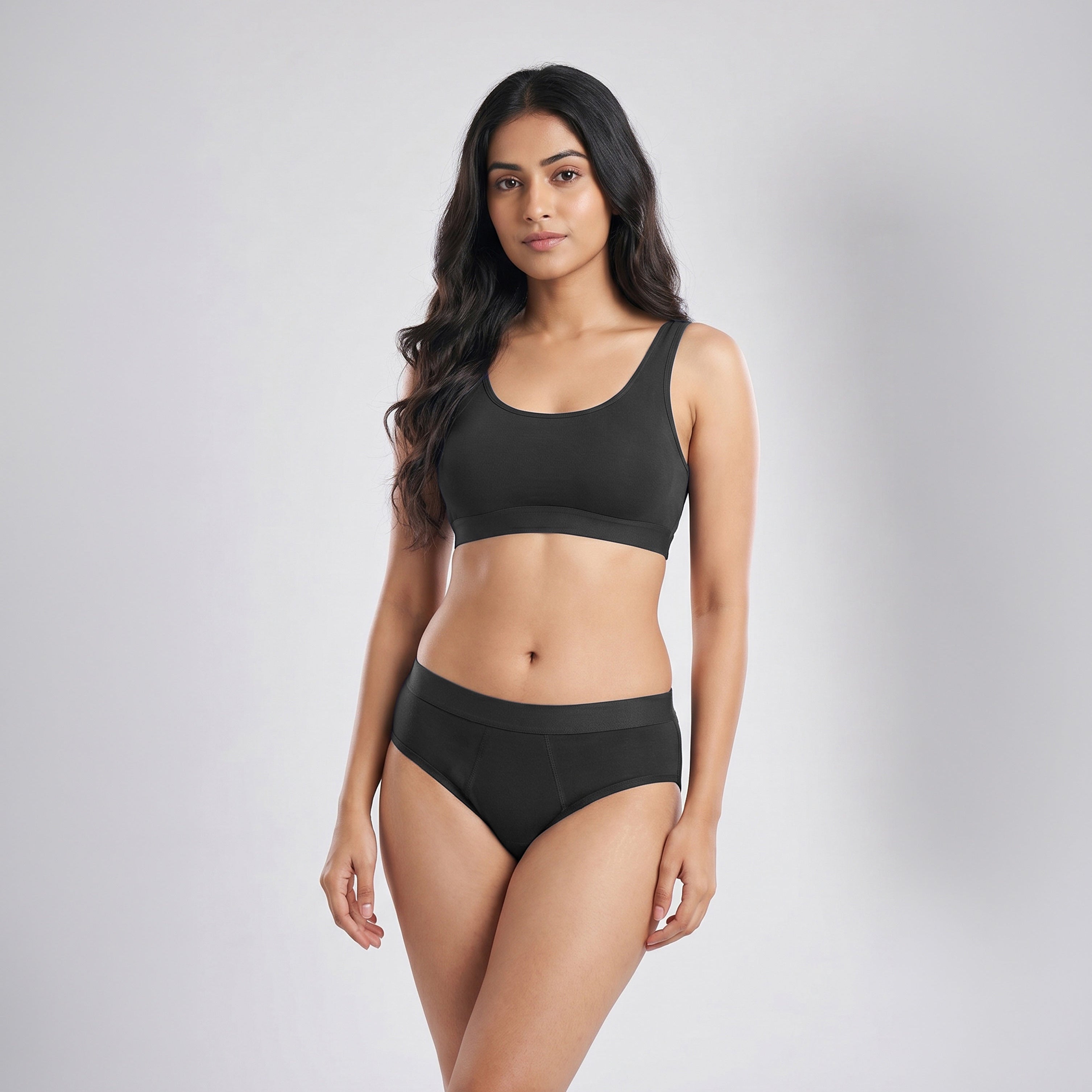 Woman wearing a black bikini set on a gray background